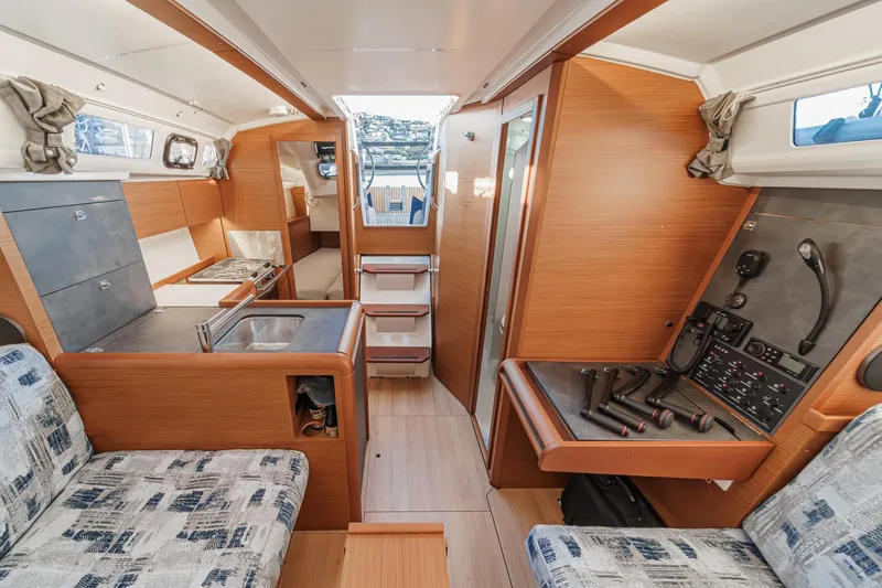 Slide: The Image of Interior of 2022 Jeanneau Sun Odyssey 349 sailboat, featuring modern wood finish and seating area. - 5