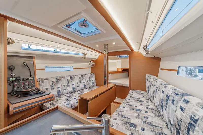 Slide: The Image of Interior of 2022 Jeanneau Sun Odyssey 349 sailboat with modern seating and navigation area. - 6