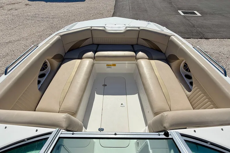 Slide: The Image of 2014 NauticStar 243DC Sport Deck boat interior with beige seating and cup holders. - 10