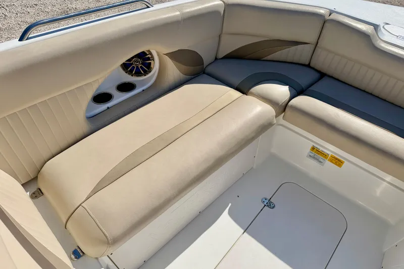 Slide: The Image of 2014 NauticStar 243DC Sport Deck boat interior with beige seating and cup holders. - 11