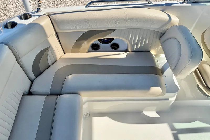 Slide: The Image of 2014 NauticStar 243DC Sport Deck boat interior seating with cup holders and cushioned seats. - 20