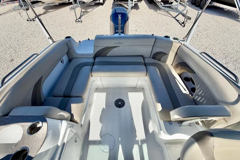 Slide: The Image of 2014 NauticStar 243DC Sport Deck interior with spacious seating and cup holders. - 22
