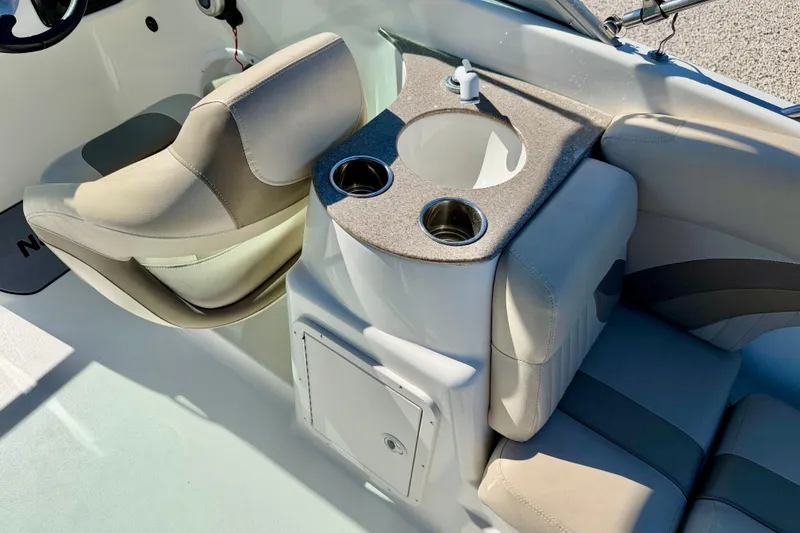 Slide: The Image of 2014 NauticStar 243DC Sport Deck interior with seating and cup holders. - 23