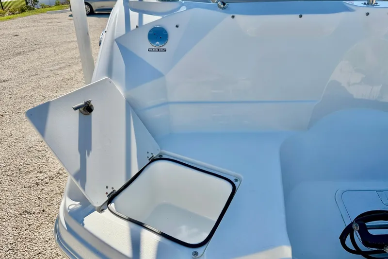 Slide: The Image of 2014 NauticStar 243DC Sport Deck boat with open storage compartment. - 24