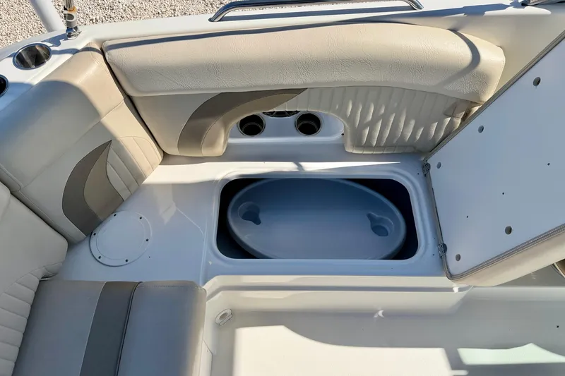 Slide: The Image of 2014 NauticStar 243DC Sport Deck interior with seating and storage compartment. - 26