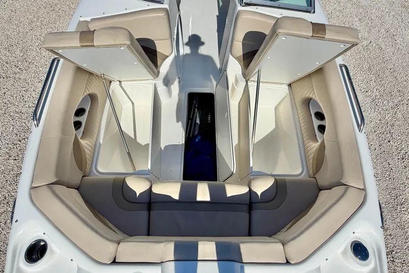 Slide: The Image of 2014 NauticStar 243DC Sport Deck boat interior with open storage compartments. - 29
