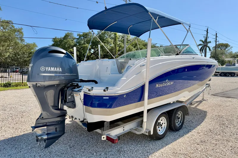 Slide: The Image of 2014 NauticStar 243DC Sport Deck boat with Yamaha engine on trailer. - 5