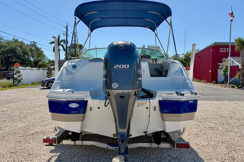Slide: The Image of 2014 NauticStar 243DC Sport Deck boat with Yamaha 200 engine, parked outdoors. - 6