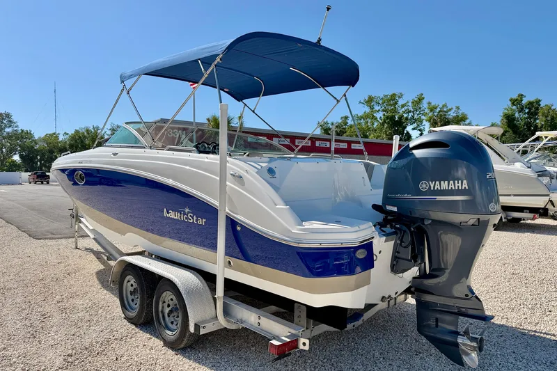 Slide: The Image of 2014 NauticStar 243DC Sport Deck boat with Yamaha outboard motor on trailer. - 7