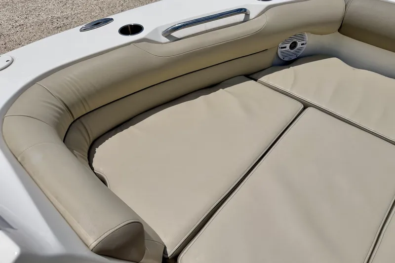 Slide: The Image of 2024 Key West 239 DFS boat interior with beige cushioned seating and speaker. - 10