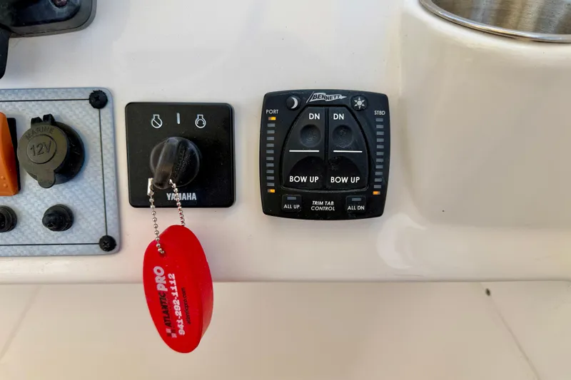 Slide: The Image of Control panel of 2024 Key West 239 DFS boat with Yamaha key and trim tab controls. - 14