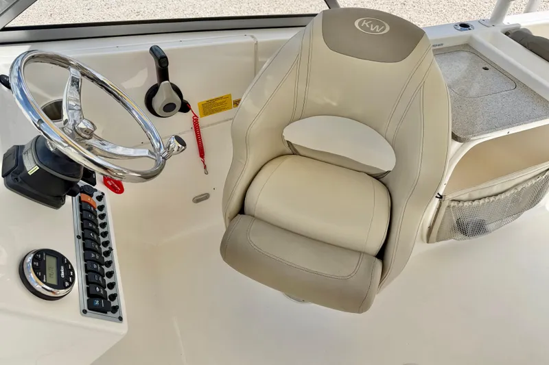 Slide: The Image of 2024 Key West 239 DFS boat helm with steering wheel and captain's chair. - 18