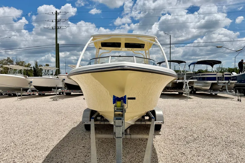 Slide: The Image of 2024 Key West 239 DFS boat on trailer under a cloudy sky. - 2