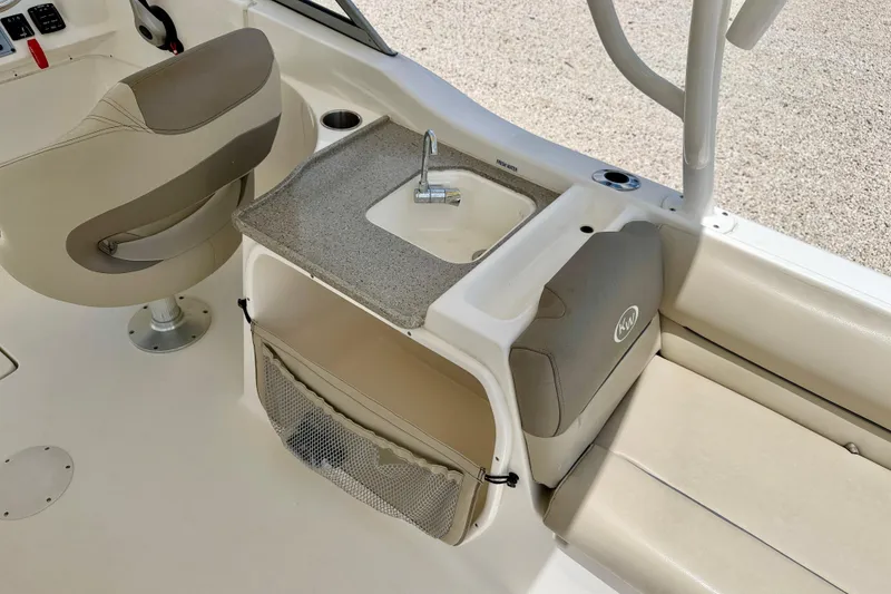 Slide: The Image of 2024 Key West 239 DFS boat interior with sink, seating, and storage. - 22