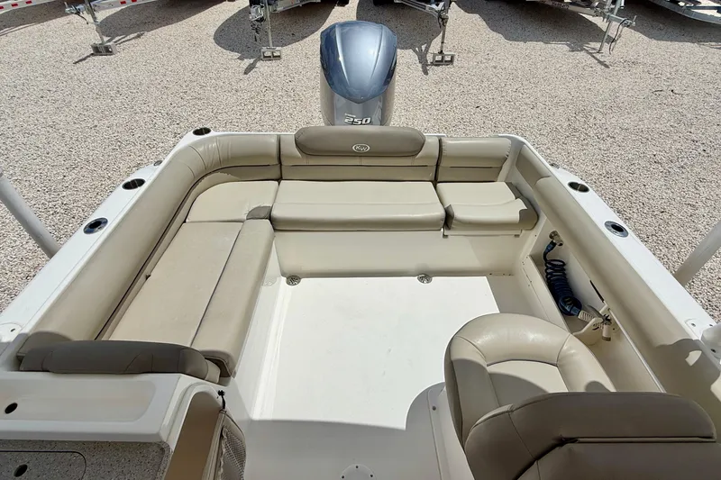 Slide: The Image of 2024 Key West 239 DFS boat interior with beige seating and outboard motor. - 23