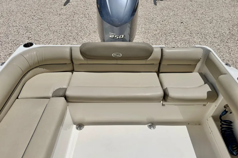 Slide: The Image of 2024 Key West 239 DFS boat with beige seating and Yamaha 250 engine. - 24