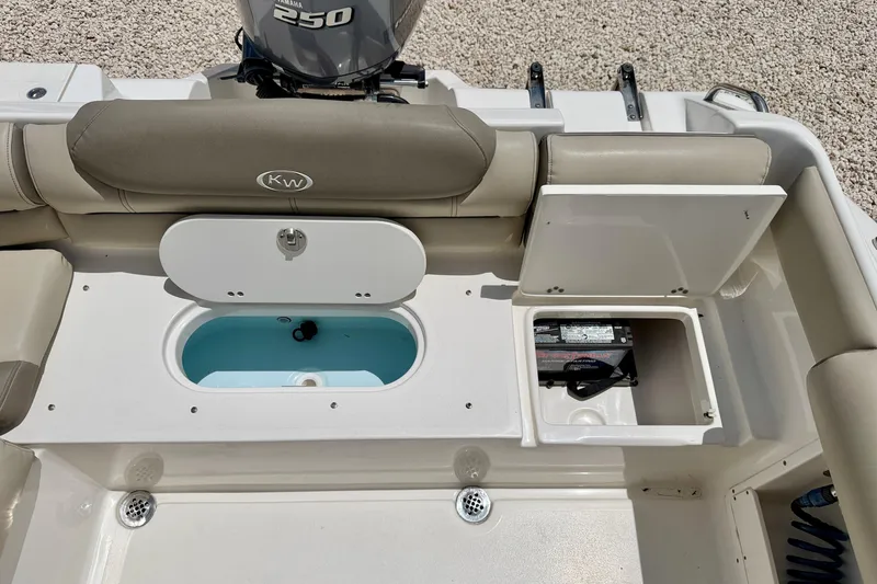 Slide: The Image of 2024 Key West 239 DFS boat interior with Yamaha 250 engine, storage compartments, and seating. - 25