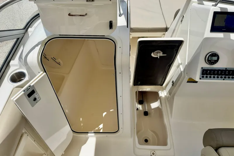 Slide: The Image of 2024 Key West 239 DFS boat interior showing storage compartments and control panel. - 26