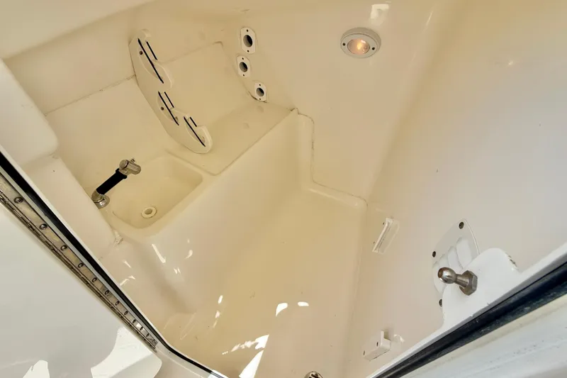 Slide: The Image of 2024 Key West 239 DFS boat interior compartment with storage and lighting features. - 27