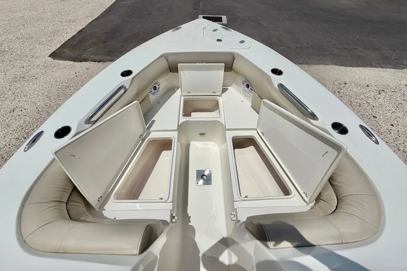 Slide: The Image of 2024 Key West 239 DFS boat interior with open storage compartments and cushioned seating. - 30