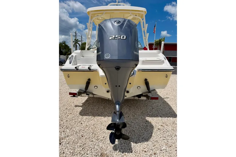 Slide: The Image of 2024 Key West 239 DFS boat with Yamaha 250 outboard motor, parked on gravel. - 32