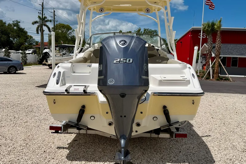 Slide: The Image of 2024 Key West 239 DFS boat with Yamaha 250 engine, parked outdoors. - 6