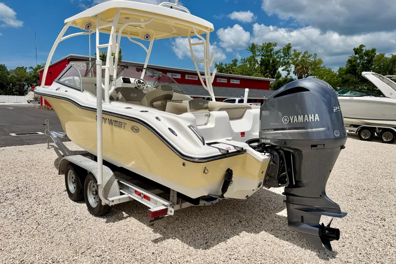 Slide: The Image of 2024 Key West 239 DFS boat with Yamaha engine on trailer, parked outdoors. - 7