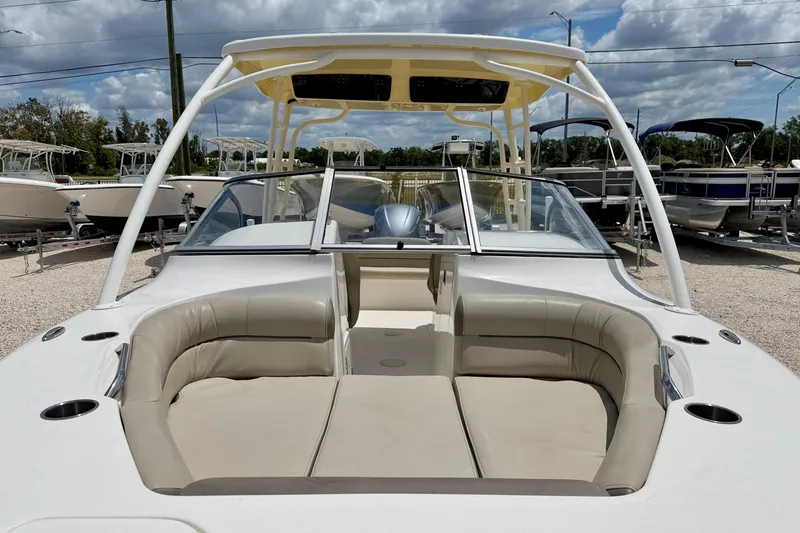Slide: The Image of 2024 Key West 239 DFS boat with spacious seating and sleek design under a cloudy sky. - 8