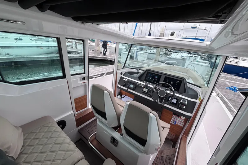 Slide: The Image of Interior of 2022 Axopar 28 Cabin boat with modern helm and seating. - 11