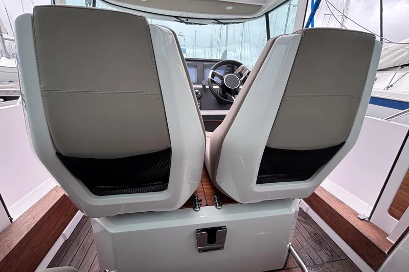 Slide: The Image of Interior view of 2022 Axopar 28 Cabin boat with modern dashboard and seating. - 12
