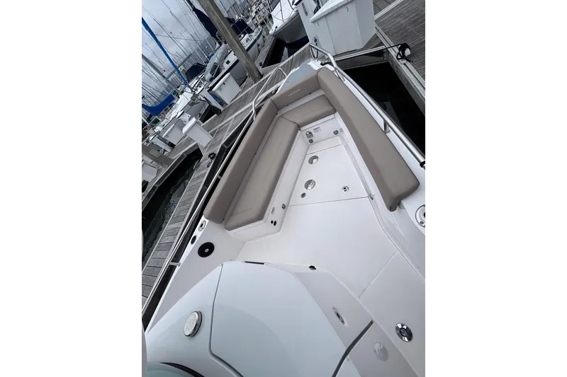 Slide: The Image of 2022 Axopar 28 Cabin helm with Garmin displays, docked at a marina. - 16