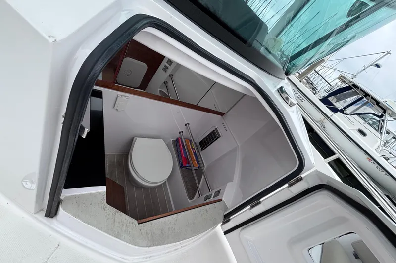Slide: The Image of 2022 Axopar 28 Cabin boat interior with open hatch and seating area. - 21