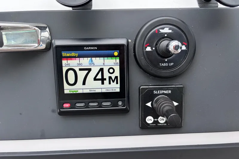 Slide: The Image of Steering wheel and throttle controls of 2022 Axopar 28 Cabin boat. - 25