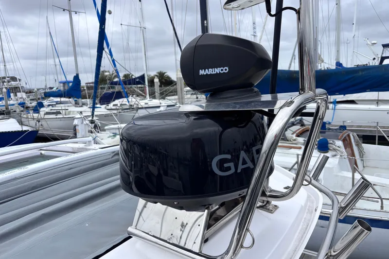 Slide: The Image of Garmin navigation display and controls on 2022 Axopar 28 Cabin boat dashboard. - 26