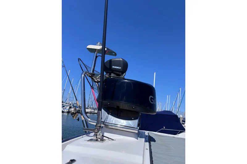 Slide: The Image of 2022 Axopar 28 Cabin with Garmin and Marinco equipment in a marina setting. - 27