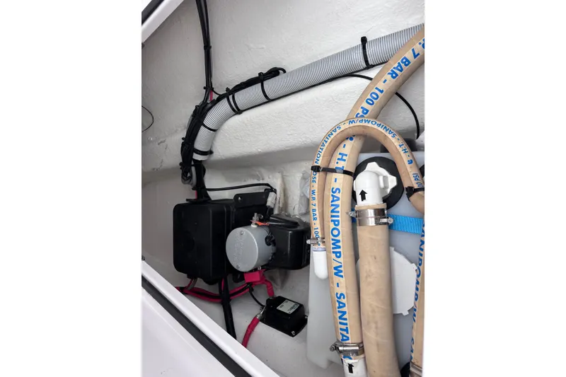 Slide: The Image of Hand holding remote control in Axopar 28 Cabin boat cockpit, 2022 model. - 29