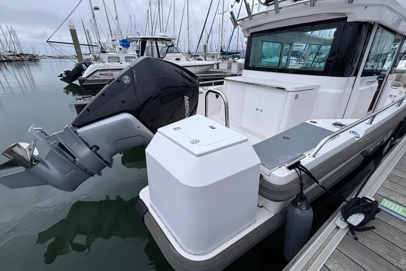 Slide: The Image of 2022 Axopar 28 Cabin boat docked with powerful Mercury outboard engine. - 5