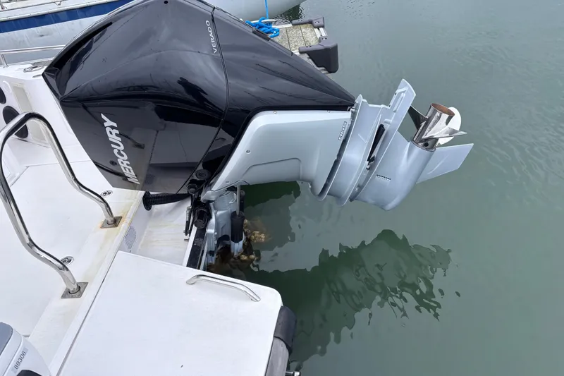 Slide: The Image of Outboard motor on a 2022 Axopar 28 Cabin boat docked at a marina. - 7