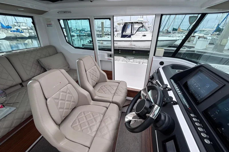 Slide: The Image of 2022 Axopar 28 Cabin with Mercury Verado outboard engine at dockside. - 8