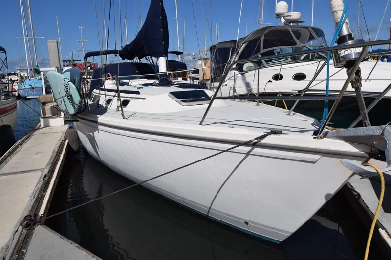The Image of 1989 Catalina 36 sailboat docked at marina, featuring sleek white hull and deck. - 0