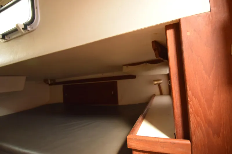 Slide: The Image of Interior cabin of 1989 Catalina 36 sailboat with wooden accents and sleeping area. - 12