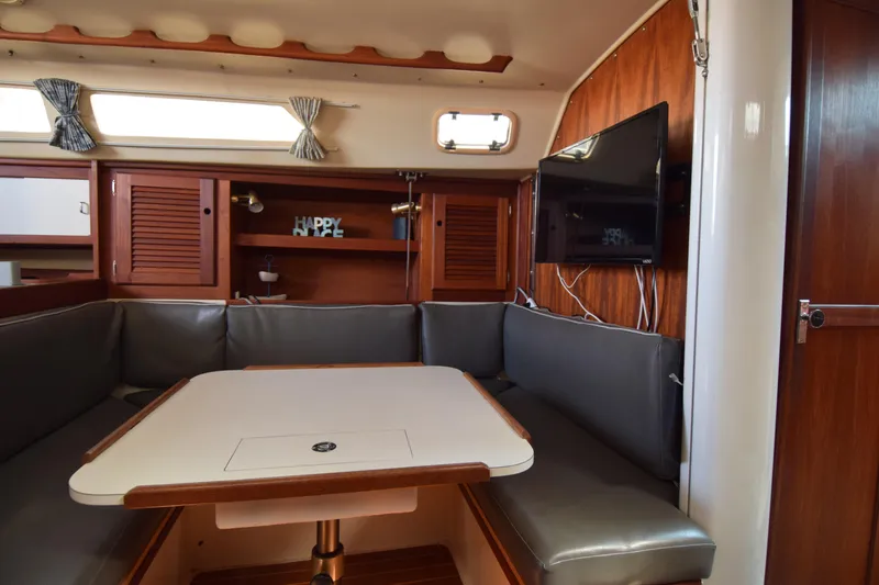 Slide: The Image of Interior of 1989 Catalina 36 sailboat with cozy seating and mounted TV. - 14