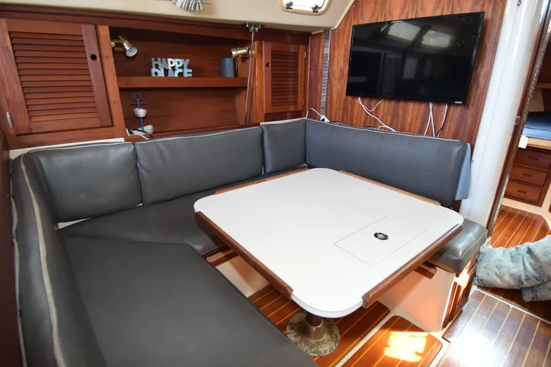 Slide: The Image of Interior of 1989 Catalina 36 sailboat with cozy seating and mounted TV. - 19