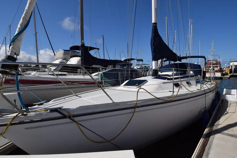 Slide: The Image of 1989 Catalina 36 sailboat docked at marina under clear blue sky. - 2