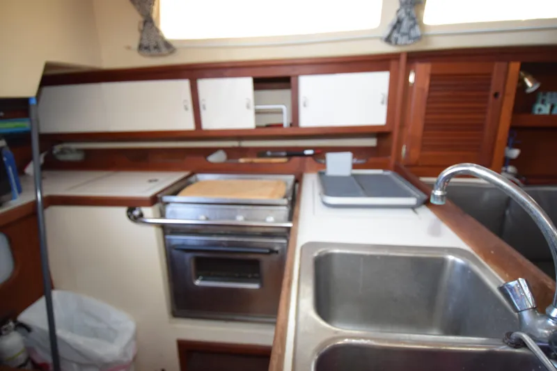 Slide: The Image of Galley kitchen in 1989 Catalina 36 sailboat with sink, stove, and storage cabinets. - 21
