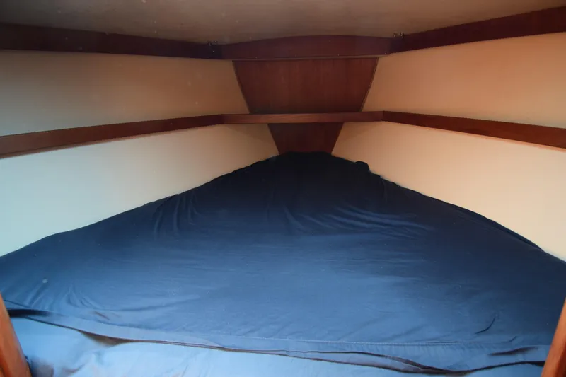 Slide: The Image of Cozy cabin interior of 1989 Catalina 36 sailboat with blue bedding. - 23