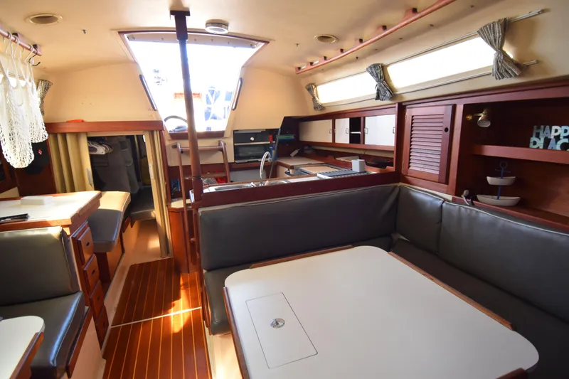 Slide: The Image of Interior of a 1989 Catalina 36 sailboat with cozy seating and wooden accents. - 24