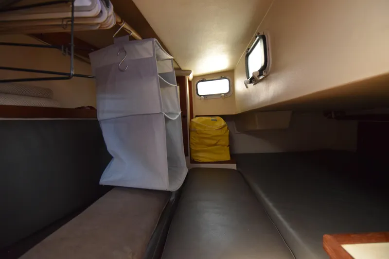 Slide: The Image of Interior cabin of a 1989 Catalina 36 sailboat with storage and seating. - 25