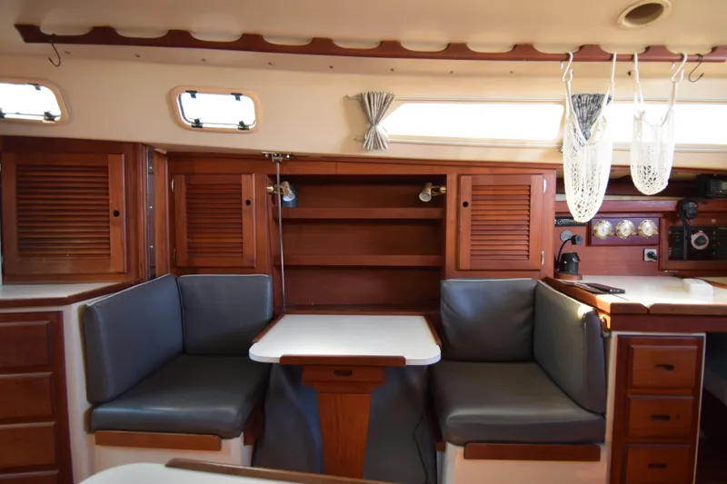 Slide: The Image of Interior of a 1989 Catalina 36 sailboat with wood cabinetry and cushioned seating. - 27