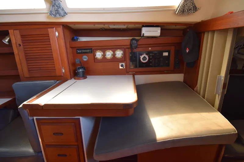 Slide: The Image of Interior of a 1989 Catalina 36 sailboat with navigation station and seating area. - 29